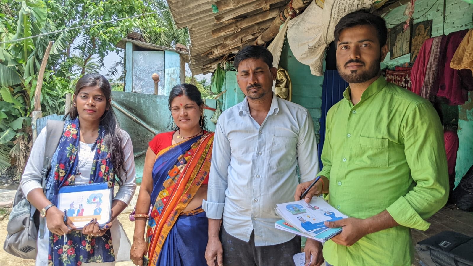 CIMMYT enumerators hold booklets with vignettes before their interaction with family farmers Kiran Devi (second from left) and Rishikesh Ram (third from left). (Photo: Nima Chodon /CIMMYT)