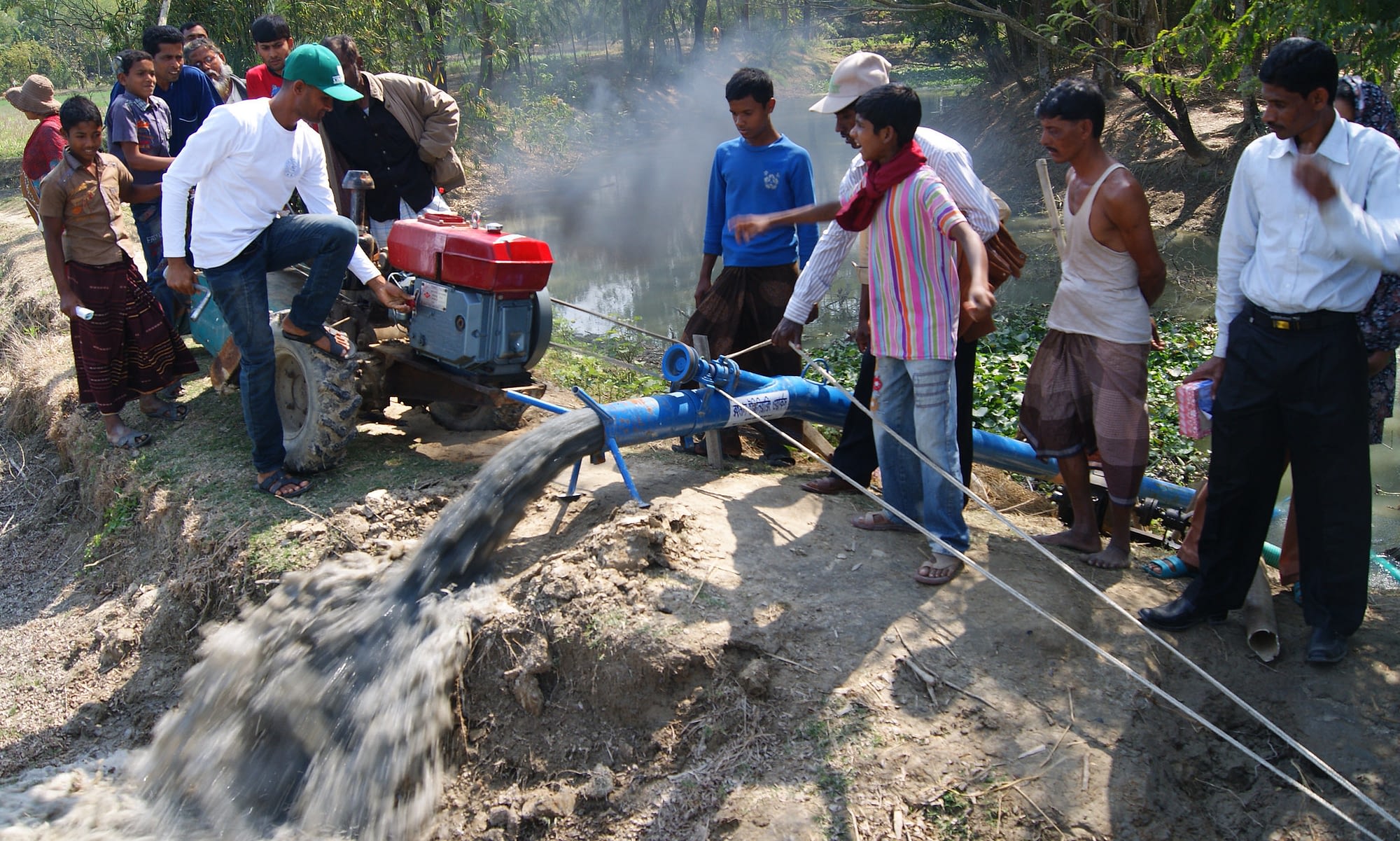 Local irrigation service providers in southern Bangladesh demonstrate the use of a two-wheeled tractor to power an axial flow pump to provide fuel-efficient surface water irrigation. (Photo: Tim Krupnik/CIMMYT)