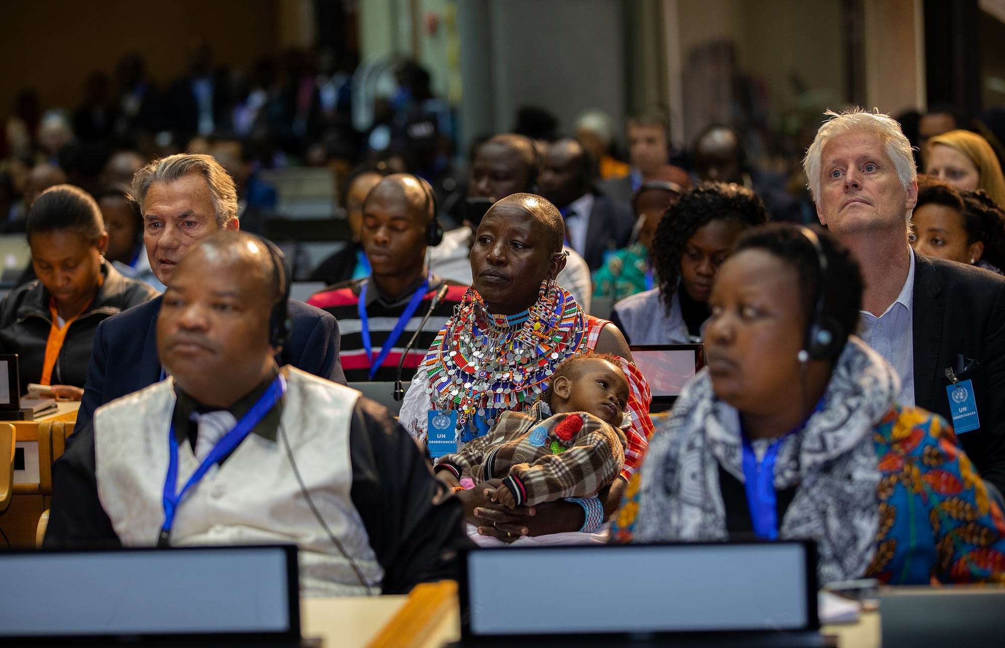 A Maasai woman holding a baby (center) attends the plenary session of the GLF Nairobi 2018. (Photo: Global Landscapes Forum)