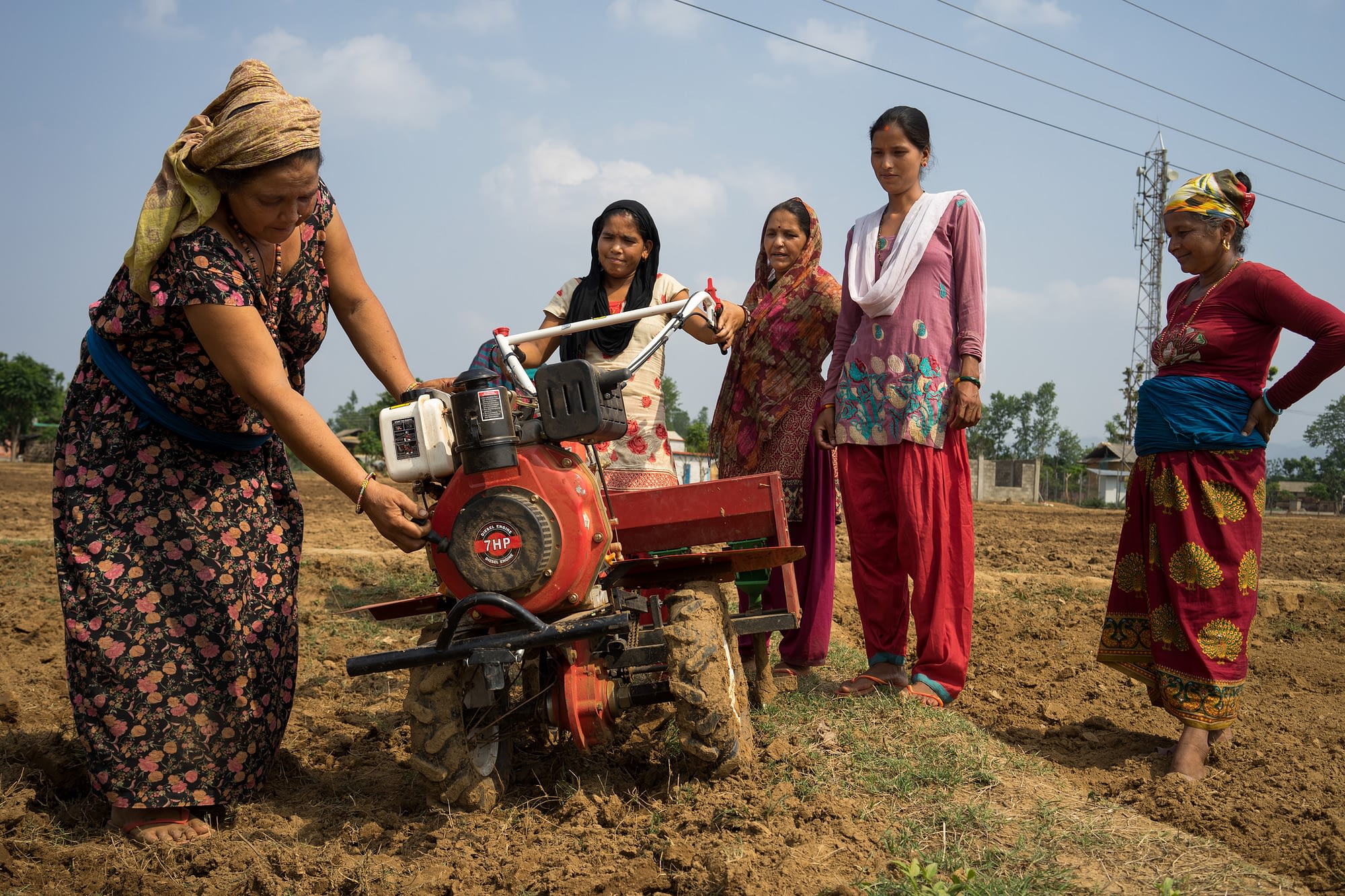 Women farmers in Nepal use a mini tiller for direct seeding. (Photo: P.Lowe/CIMMYT)