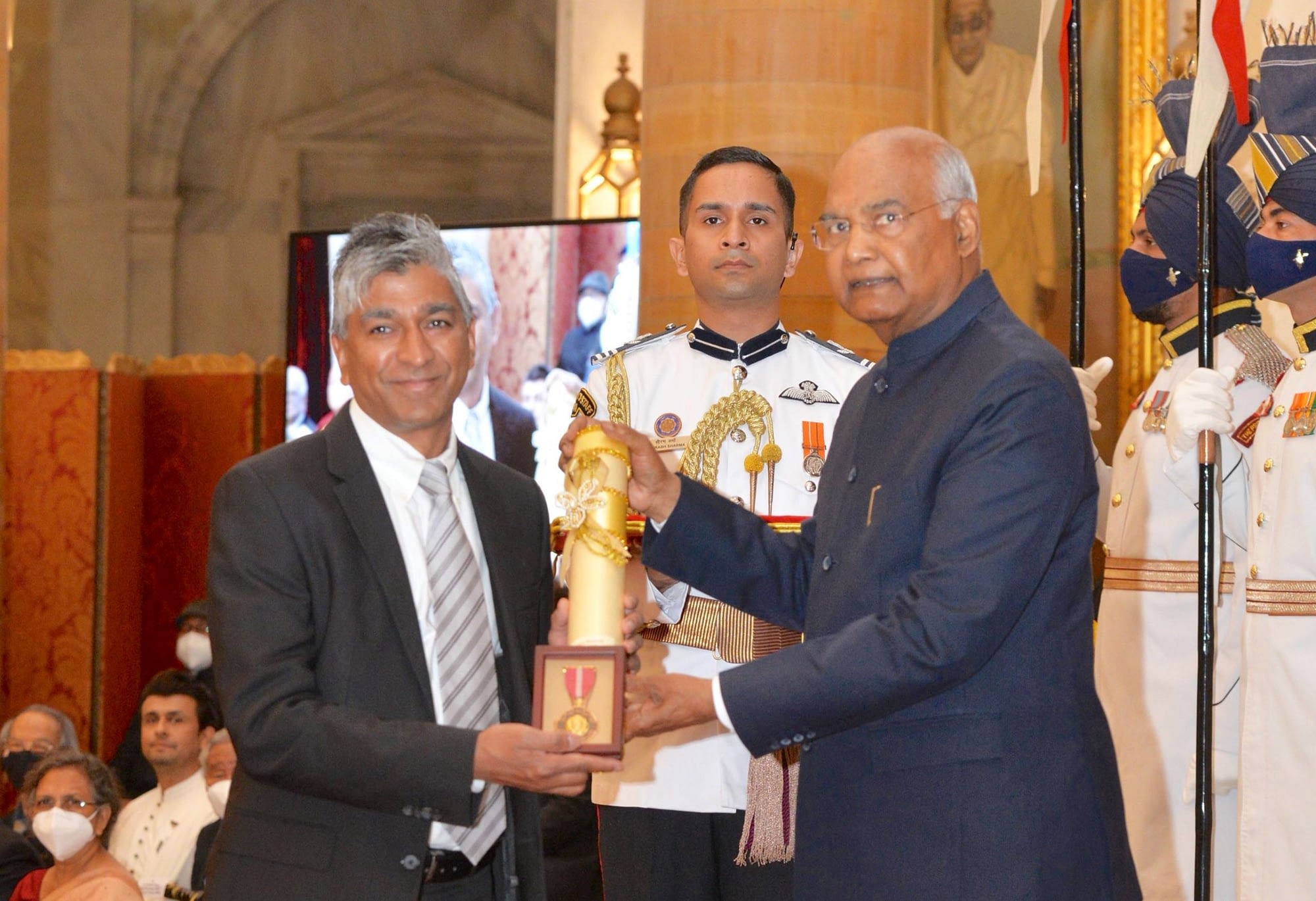 Jai Prakash Rajaram (left) receives the Padma Bhushan Award on behalf of his late father, Sanjaya Rajaram, from the President of India, Ram Nath Kovind. (Photo: Government of India)