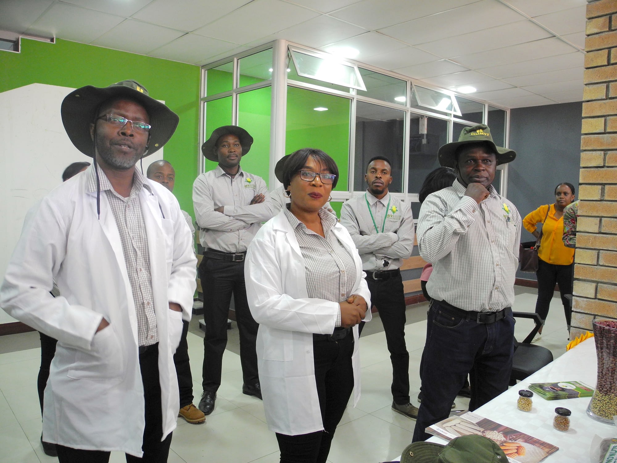 Emmanuel Angomwile (left) and Stephanie Angomwile (center) answer visitors’ questions at their seed company, Afriseed. (Photo: Jennifer Johnson/CIMMYT)