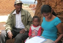 Nilupa Gunaratna, the paper’s main author, helps a farmer and his daughter fill out a QPM survey in Karatu, Tanzania.