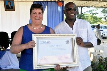 Ms, Virginia Palmer (left), US Ambassador to Malawi, and Dr Peter Setimela (CIMMYT–SARO), with the Feed the Future Malawi Improved Seed Systems and Technologies Project certificate of launch. Malawi heavily relies on agriculture for economic growth, with 80 percent of the country’s population engaged fulltime in agriculture.