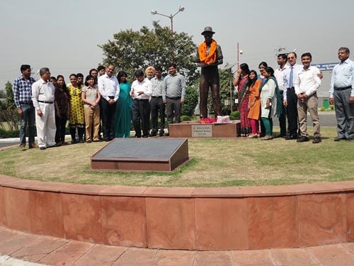 BISA and CIMMYT staff pay tribute to Norman Borlaug, in the shadow of his statue and accomplishments. Photo: Meenakshi Chandiramani