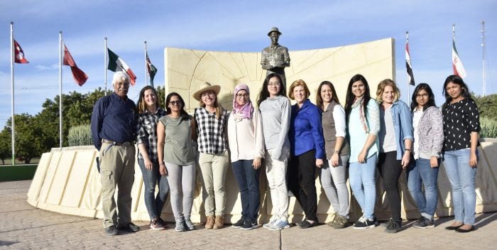 Winners of the Jeanie Borlaug Laube Women in Triticum (WIT) Early Career Award pose in front of the statue of the late Nobel Peace laureate, Dr. Norman E. Borlaug. Included in the photo are Amor Yahyaoui, CIMMYT wheat training coordinator (far left), Jeanie Borlaug Laube (center, blue blouse), and Maricelis Acevedo, Associate Director for Science, the Delivering Genetic Gain in Wheat Project (to the left of Jeanie Borlaug Laube). Photo: CIMMYT/Mike Listman