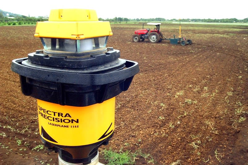Precision levelers are climate-smart machines equipped with laser-guided drag buckets to level fields so water flows evenly into soil, rather than running off or collecting in uneven land. This allows much more efficient water use and saves energy through reduced irrigation pumping, compared to traditional land leveling which uses animal-powered scrapers and boards or tractors. It also facilitates uniformity in seed placement and reduces the loss of fertilizer from runoff, raising yields. (Photo: CIMMYT)