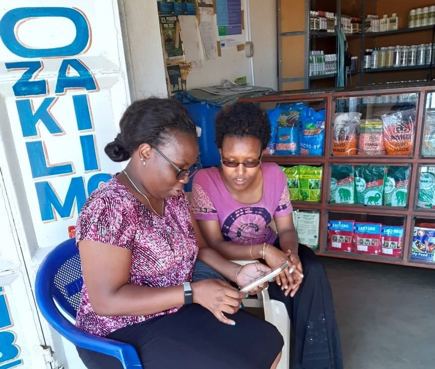 Enumerator Mary Mdache (left) interviews Shangwe Stephano, staff of BAYDA agrovet shop in Haydom town, Mbulu district, Tanzania. (Photo: Furaha Joseph)